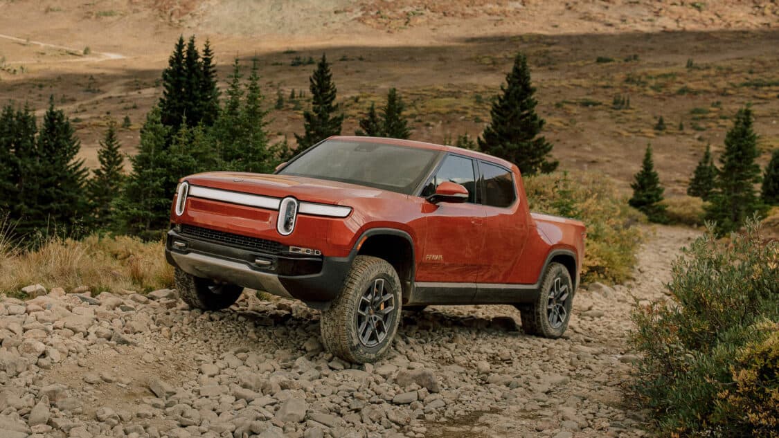 Image showcasing Rivian R1T electric truck facing uphill off-road challenges