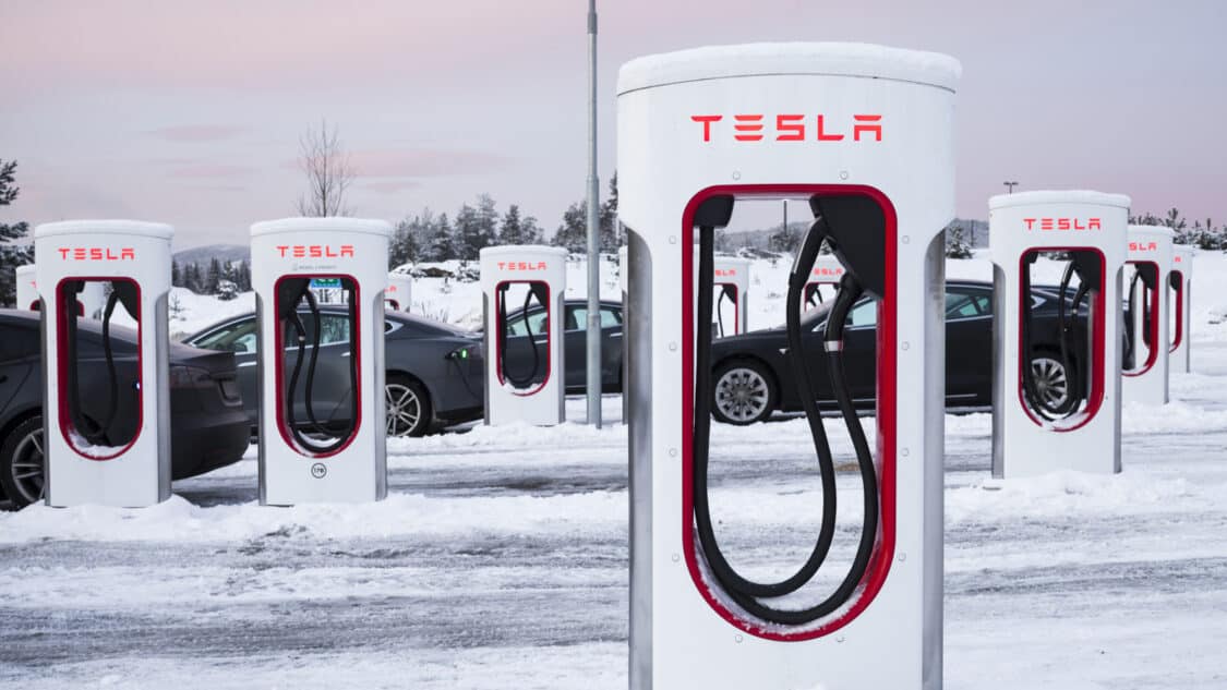 Image showcasing Tesla Supercharging station with 44 stalls. Cold weather affects electric vehicles.
