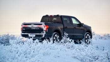 Image showcasing black 2022 Ford F-150 Lighting EV truck in snow and cold weather