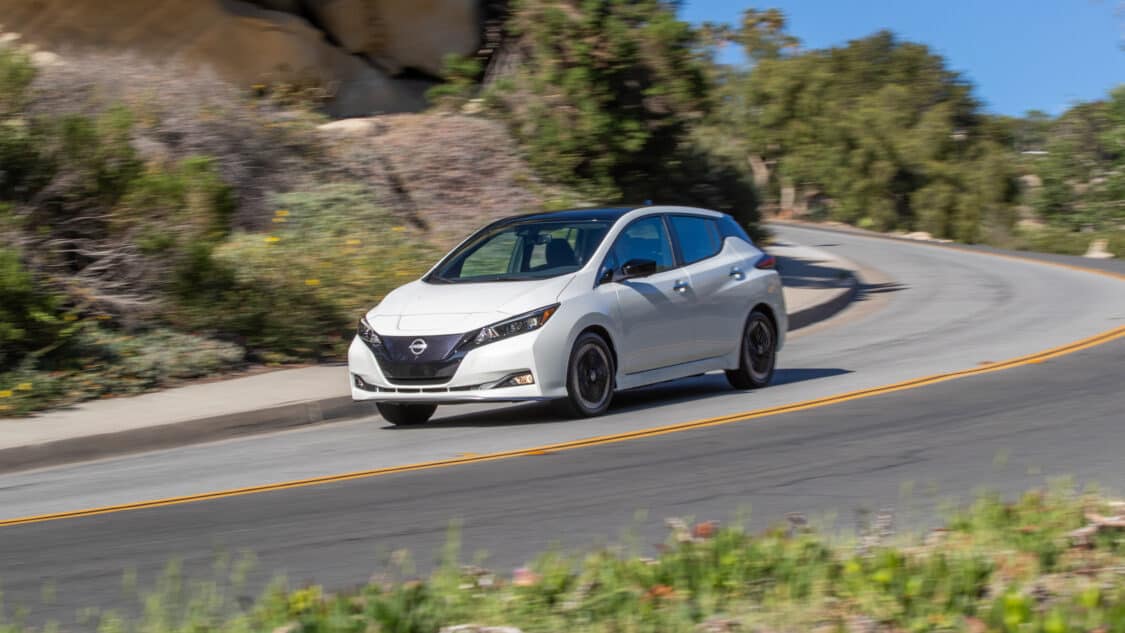 Image showcasing 2023 Nissan Leaf on public mountainside highway