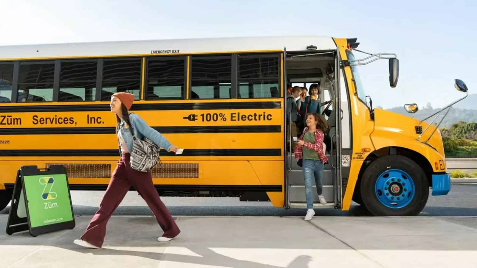 Zum Electric school buses parked and letting children off