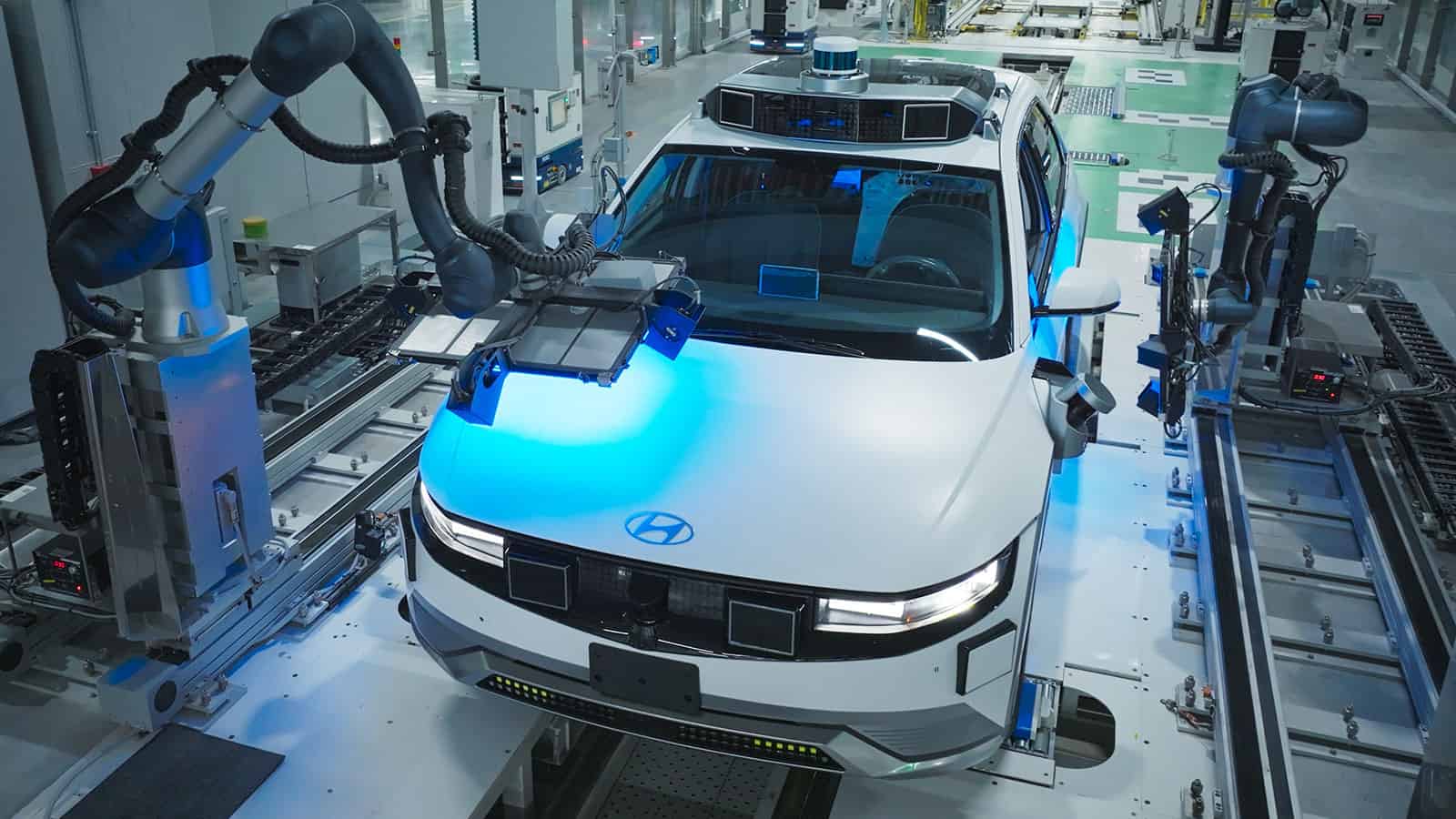 Robot arm assembling Hyundai vehicle, new plant to allow electric vehicle tax credit 2024