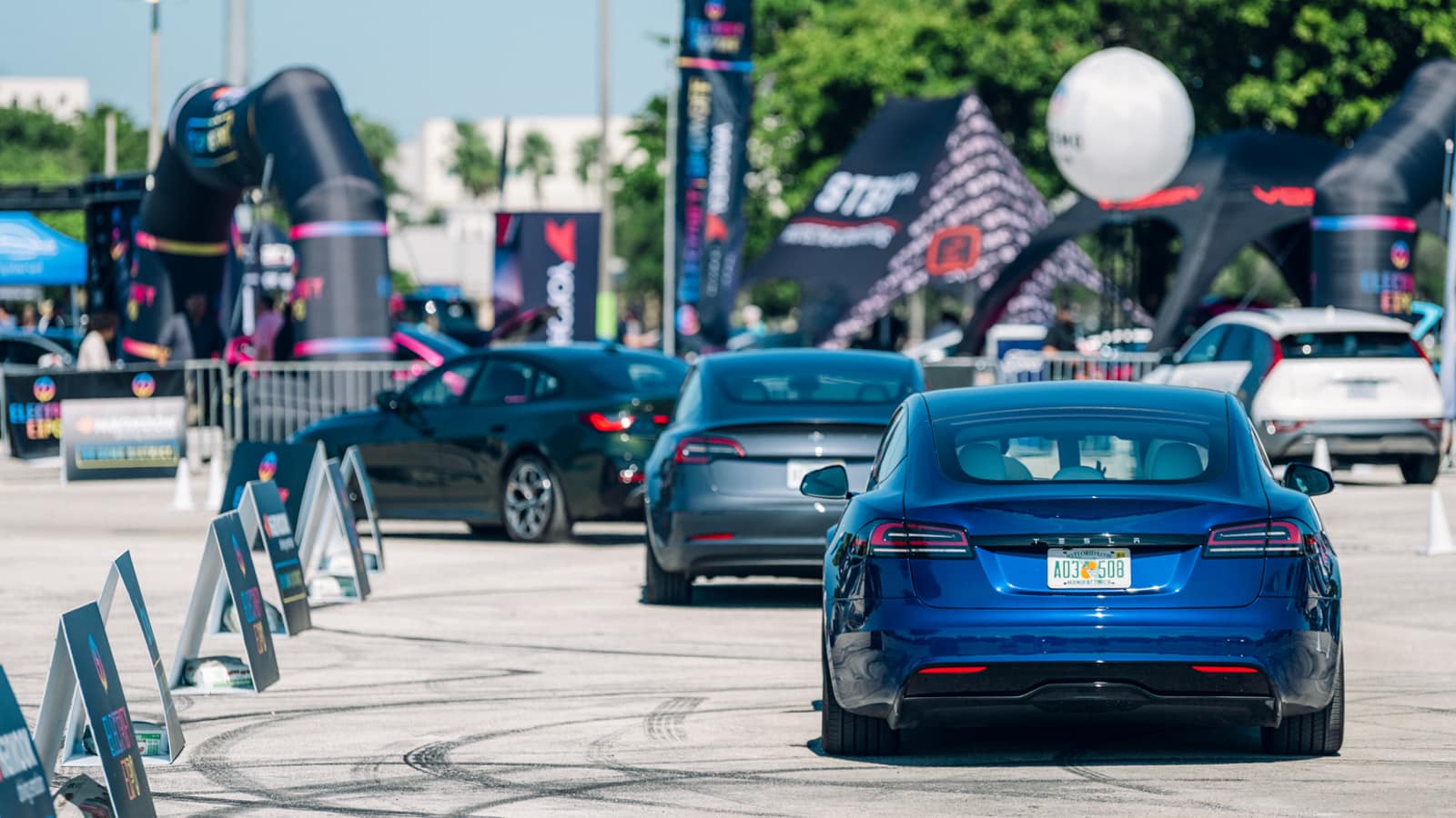 Electrify Expo attendees test driving the Telsa Model 3 and Tesla Model S - Electric Vehicles Not Selling Fast