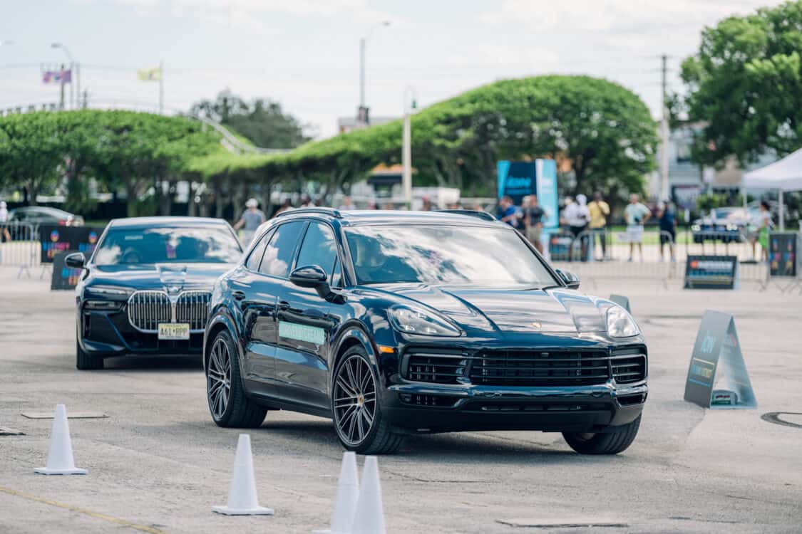 Electrify Expo attendees test driving the Porsche Macan EV electric SUV and BMW i7 electric sedan