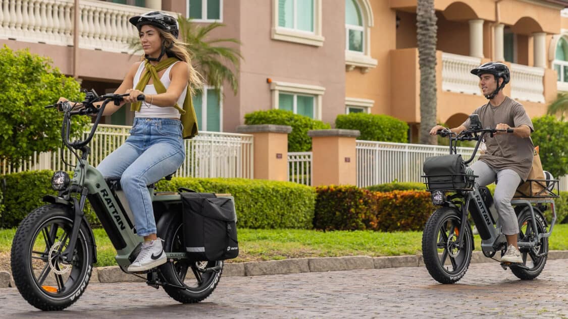Woman and man riding the Rattan Quercus Cargo E-Bike with Dual Battery, Torque Sensor, and Hydraulic Suspension
