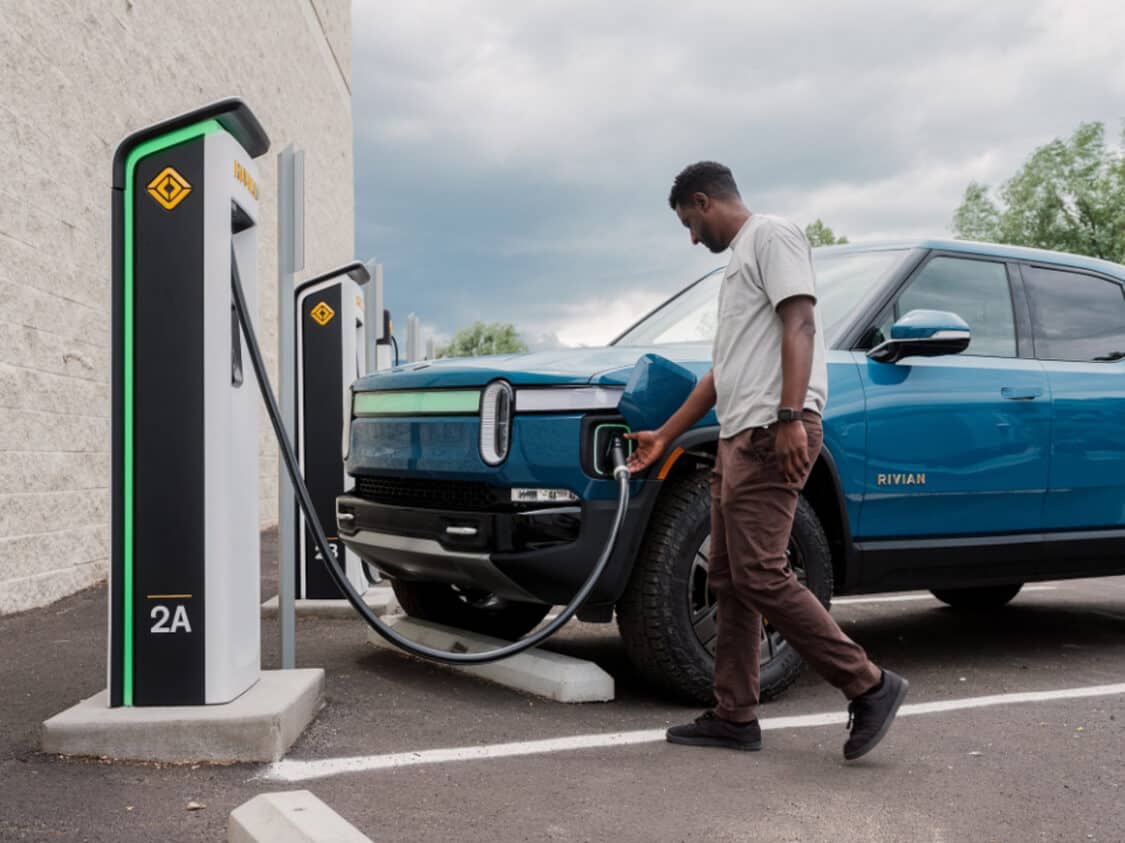 Rivian Vehicles Now Compatible with Tesla Supercharger Network - man charging