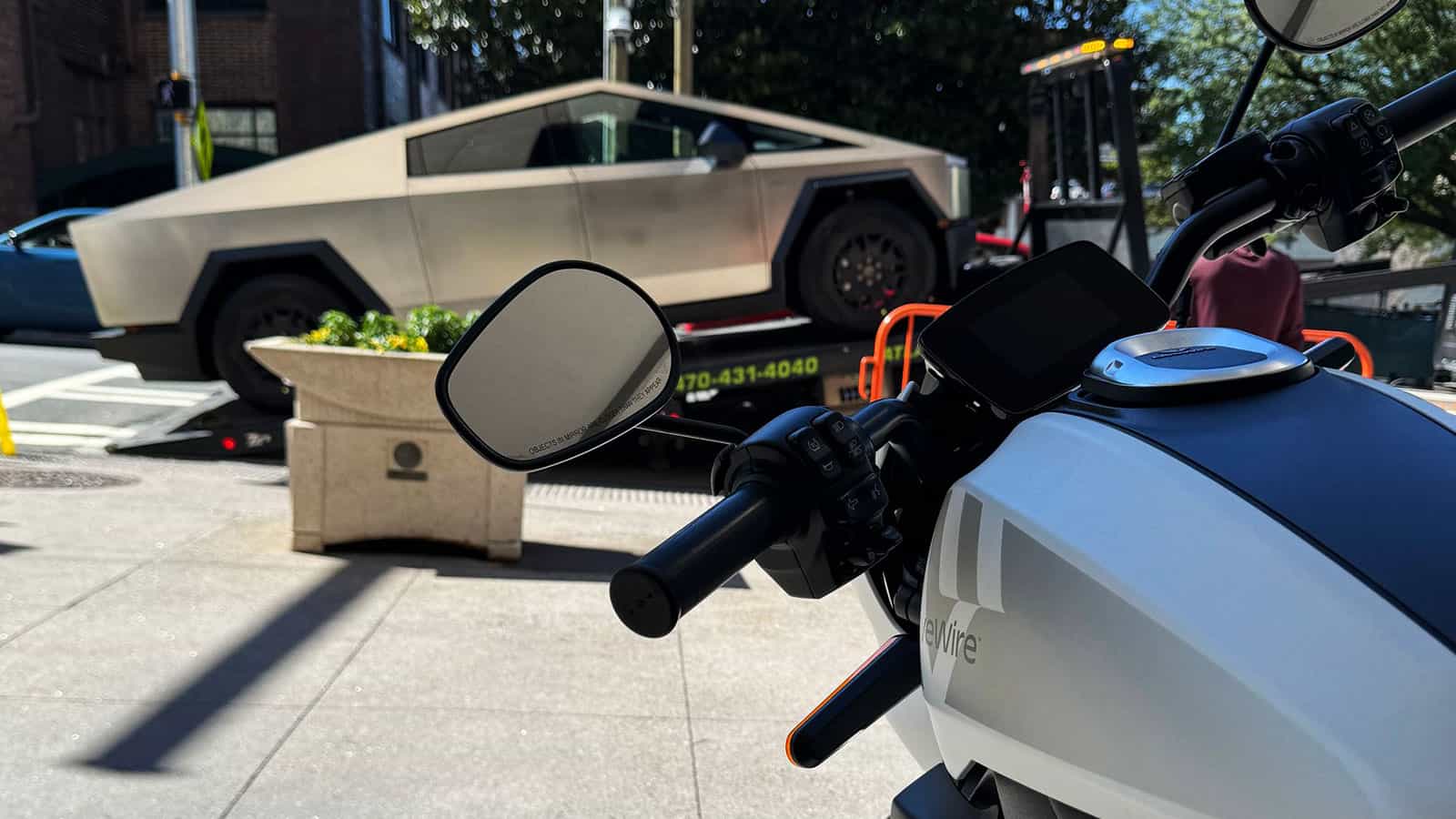 View of Tesla Cybertruck over electric motorcycle handle bars at Atlanta City Hall EV day