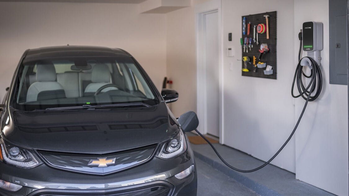 JuiceBox best home ev charger in garage and plugged into EV