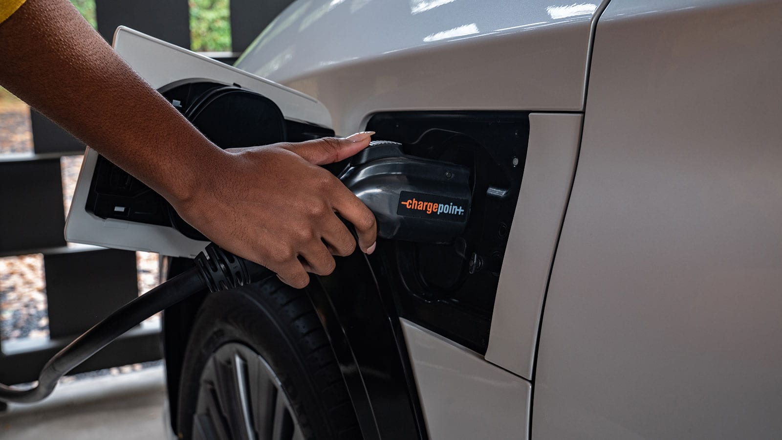 close up of a woman's hand plugging into Lexus with Chargepoint charger, ev infrastructure