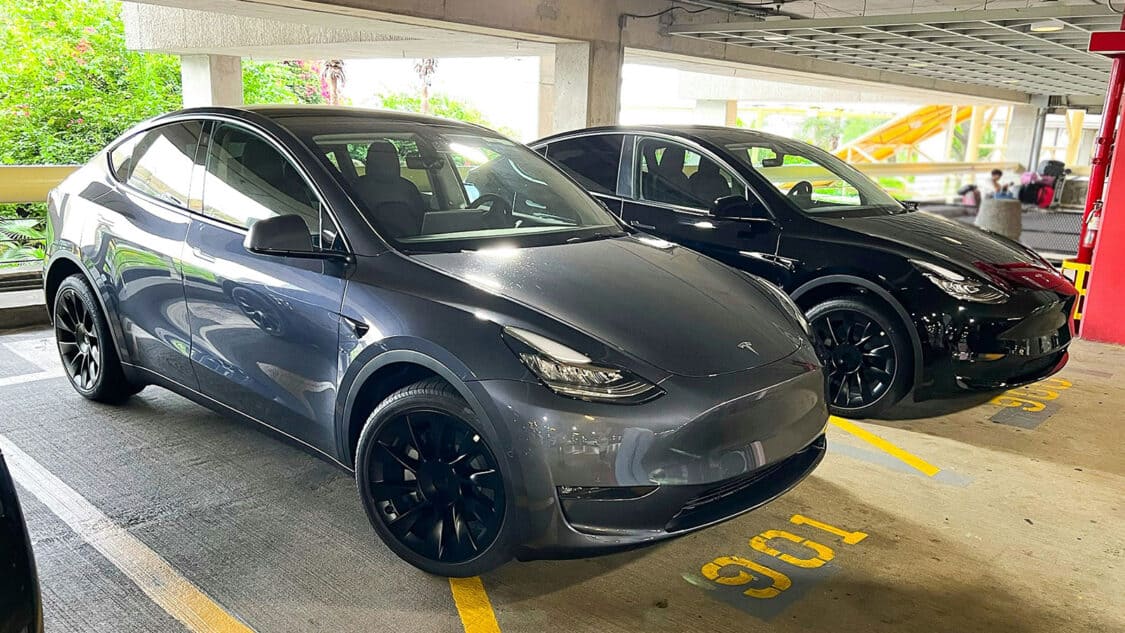 Electric car rental with two teslas in a parking garage