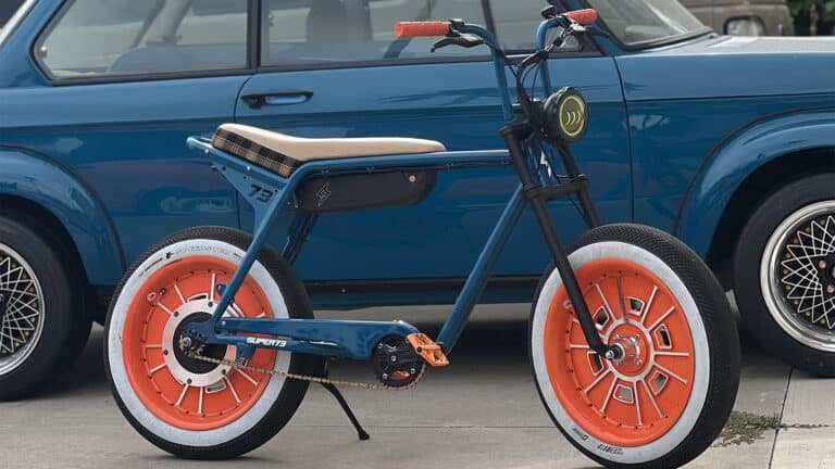Neil Tjins' Super73 electric bike in front of BMW 2002 custom builds