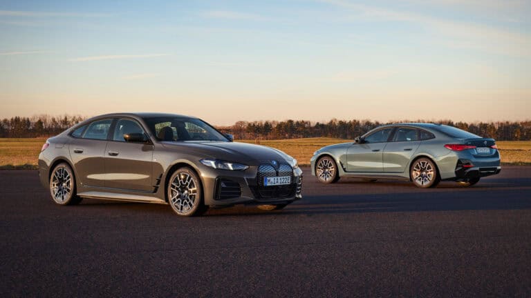 BMW 4 Series two electric vehicles parked near a field