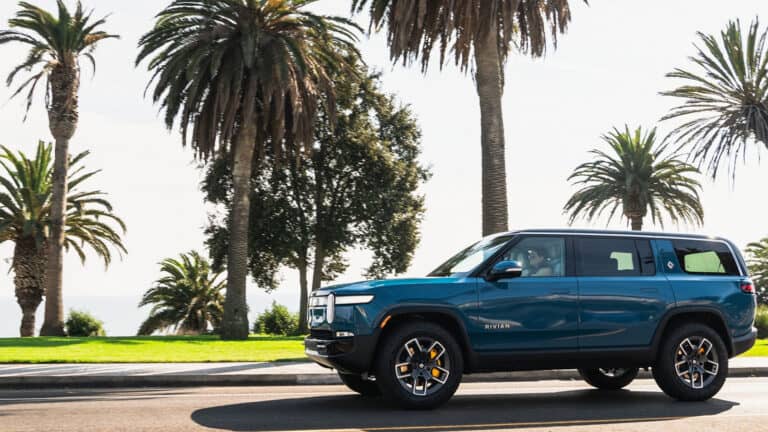 Rivian R1S next to palm trees eligible ev tax credits