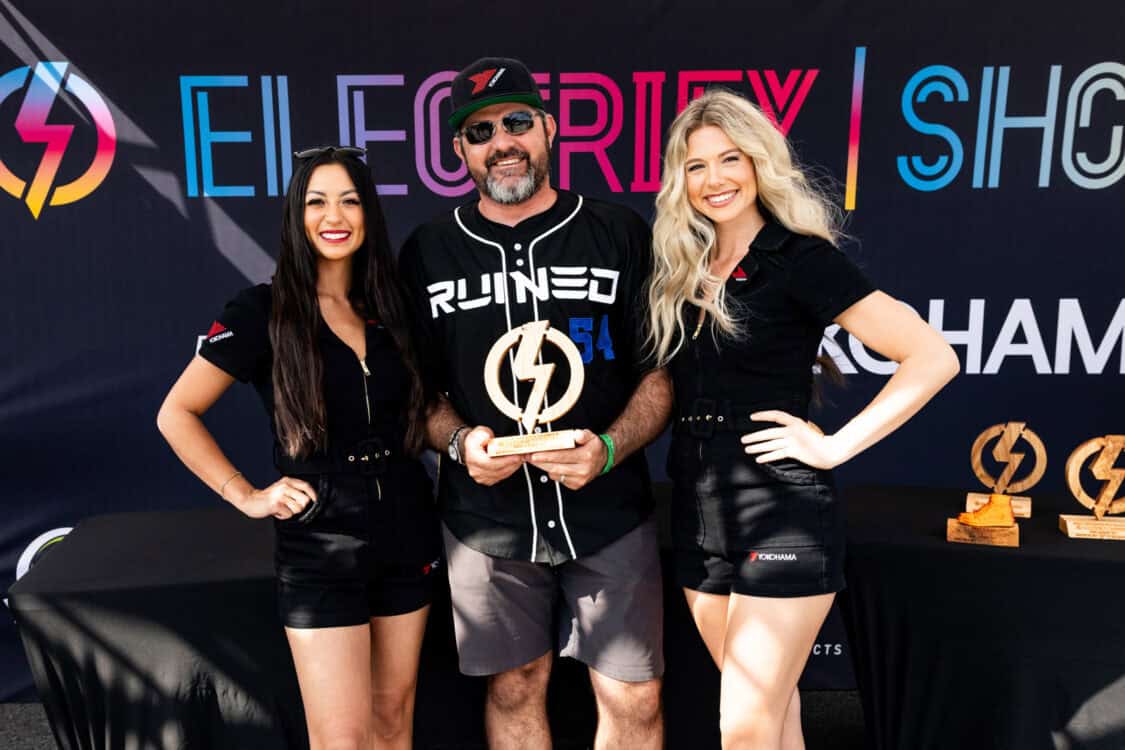 Jason Halvorsen holds award next to Yokohama Tires spokesmodels at Electrify Showoff Orlando 2024