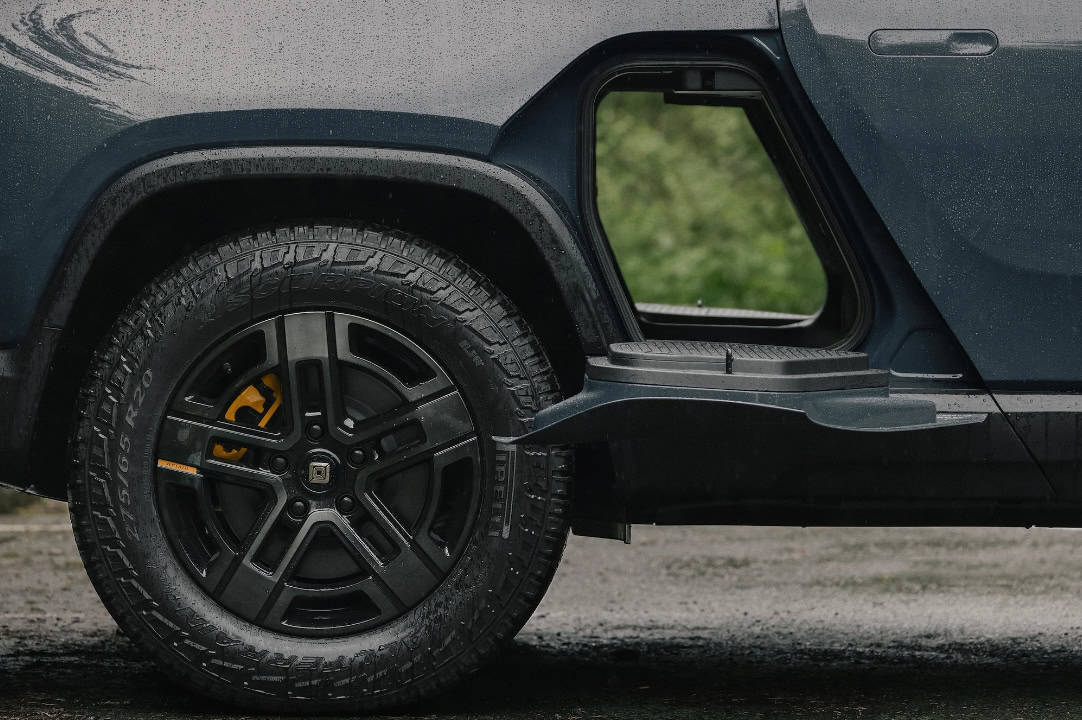 Rivian R1T electric truck with 20 inch all terrain dark wheels.