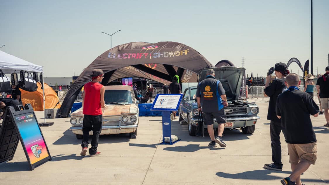 Terry Breheny's 1961 Chevy Corvair Lakewood 700 and John Wilson's 1966 Ford Mustang Coupe at Electrify Showoff in Denver