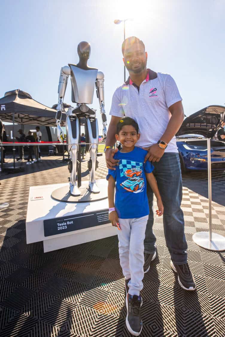 Family standing next to the 2023 Tesla Bot at Electrify Expo