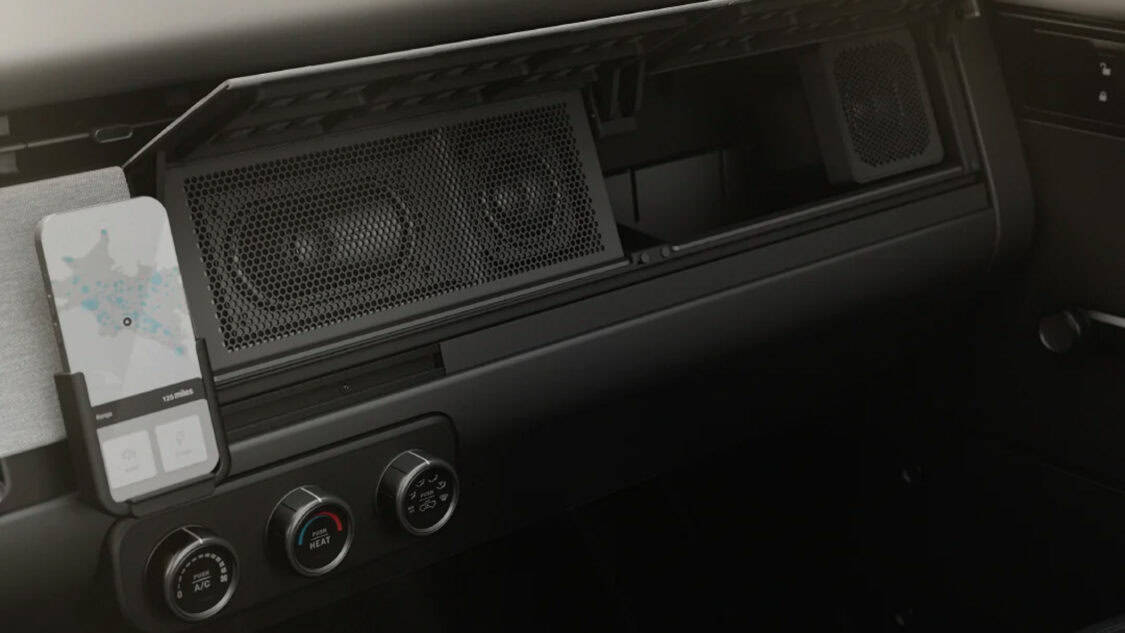 Slate Auto EV interior with optional accessories, like speakers, phone holder, and climate controls with knobs.