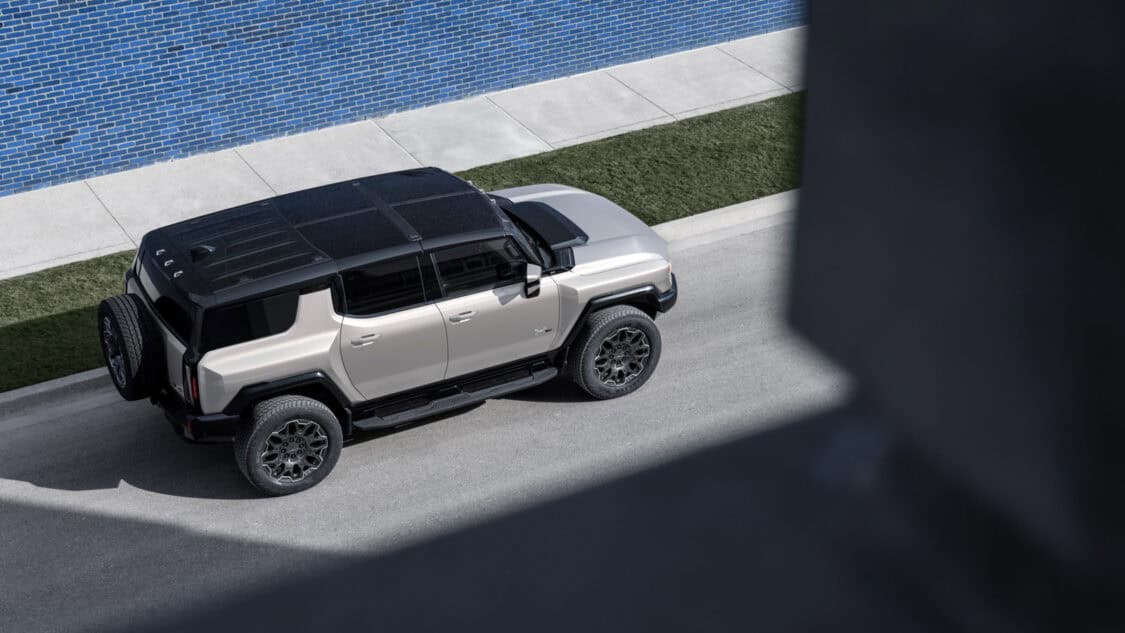 Top rear 3/4 view of the 2026 GMC Hummer EV SUV in Granite Drift exterior color.