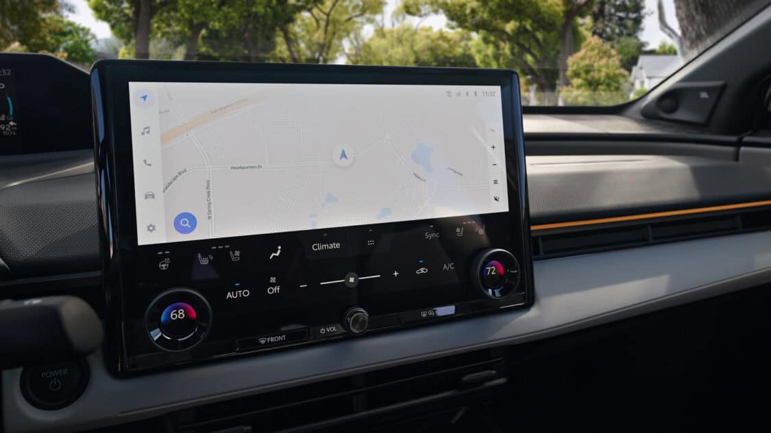 Close-up view of the 2026 Toyota bZ’s central touchscreen displaying navigation and climate controls, with dashboard and power button visible.
