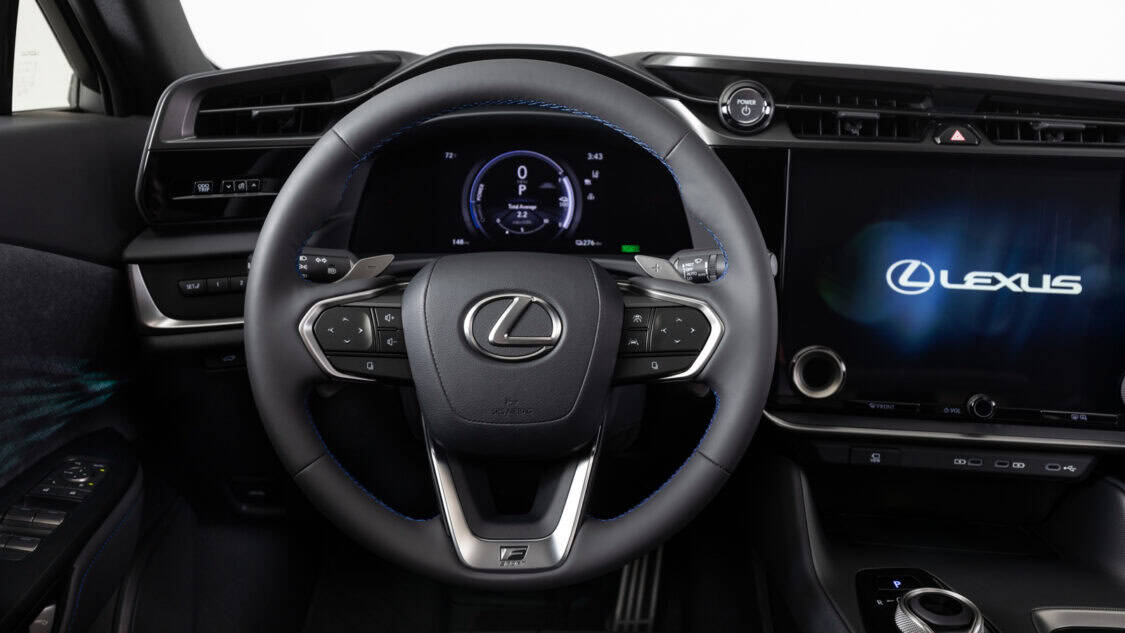 Interior steering wheel view of a 2026 Lexus RZ 550e F SPORT electric SUV in Wind color, light gray with subtle metallics.