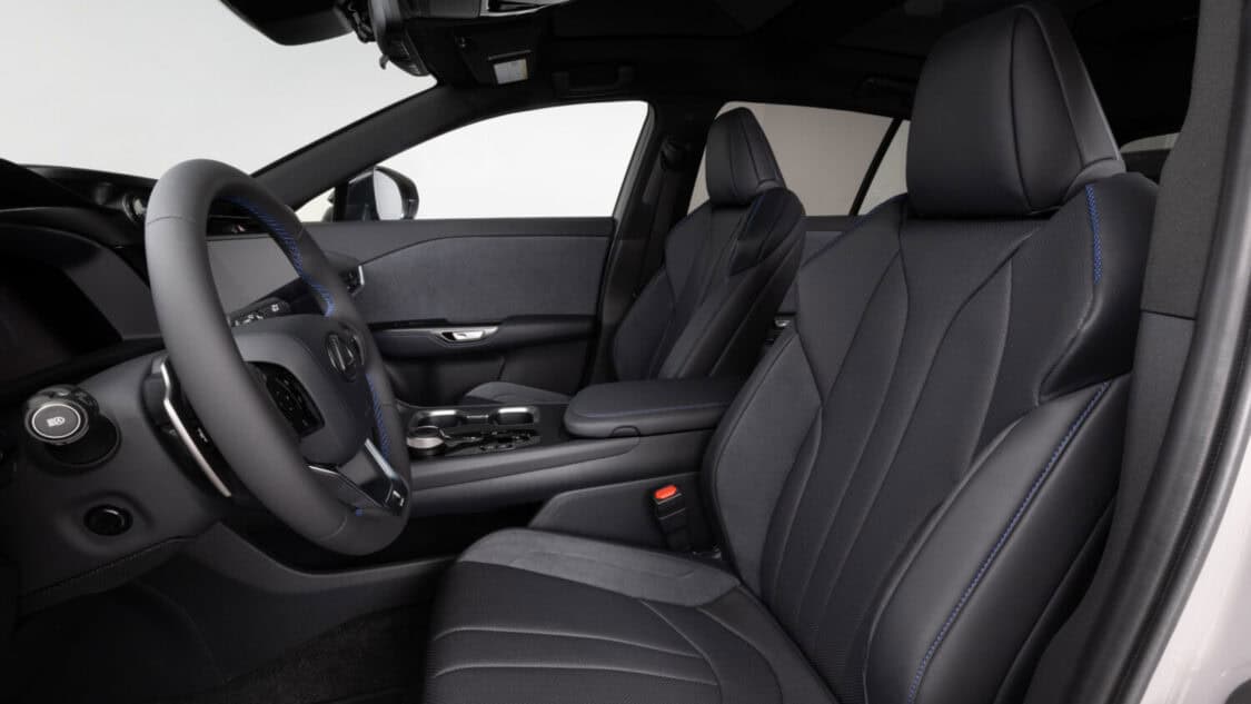 Interior driver profile view of a 2026 Lexus RZ 550e F SPORT electric SUV in Wind color, light gray with subtle metallics.