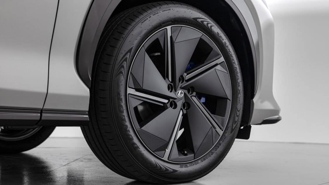 View of wheels of a 2026 Lexus RZ 550e F SPORT electric SUV in Wind color, light gray with subtle metallics.