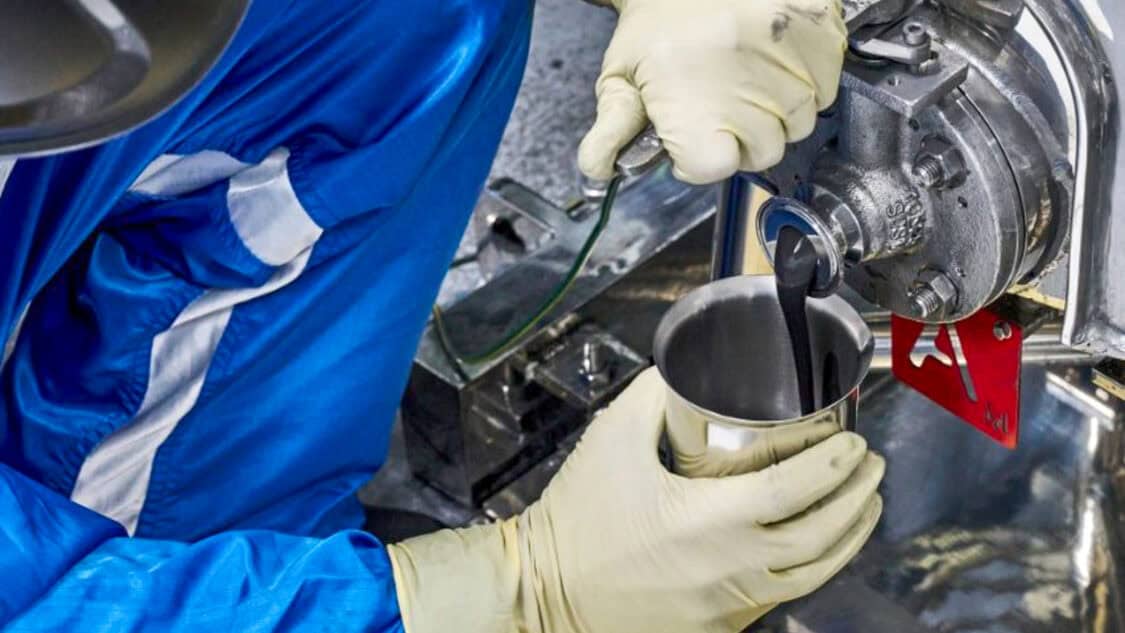 A battery technician at the General Motors Wallace Battery Cell Innovation Center takes a chemistry slurry sample. (Photo by Steve Fecht for General Motors)