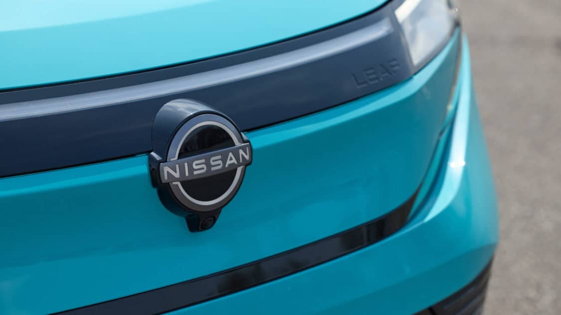 2026 Nissan Leaf compact electric SUV in Seabreeze Blue, showcasing its new crossover design and updated LED headlights and badging.
