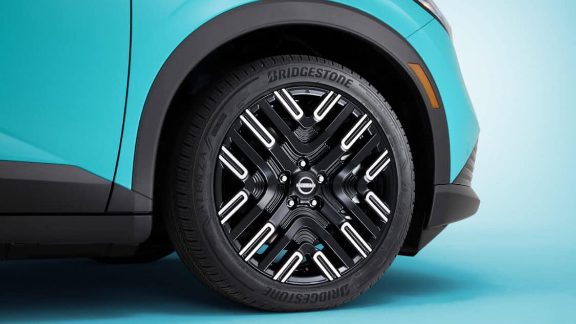 Close-up of the 2026 Nissan Leaf’s 19-inch alloy wheel with Bridgestone Alenza Sport tire, featuring the signature 2-3 design pattern.