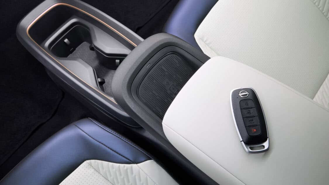 Wireless charging pad in the 2026 Nissan Leaf’s center console, featuring textured grip and minimalist interior trim with blue and white accents.