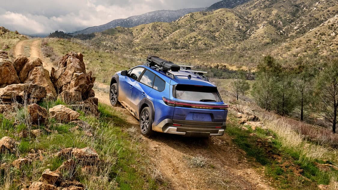 2026 Subaru Trailseeker all-electric SUV on a dirt trail, highlighting its AWD, ground clearance, and off-road capability.