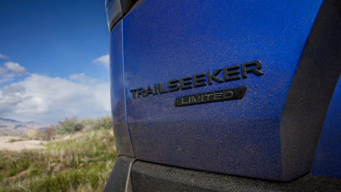 Close-up of the 2026 Subaru Trailseeker Limited badge on a dusty blue EV, highlighting its off-road use and all-electric identity.