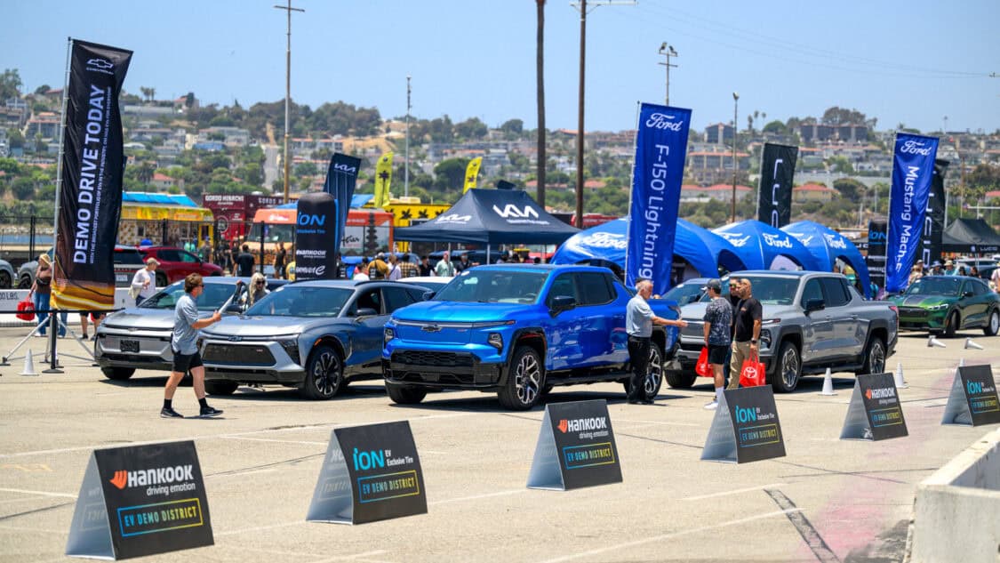 EV Demo District at Electrify Expo, featuring Chevrolet Silverado EV, Chevrolet Blazer EV, and Ford Mustang Mach-e.