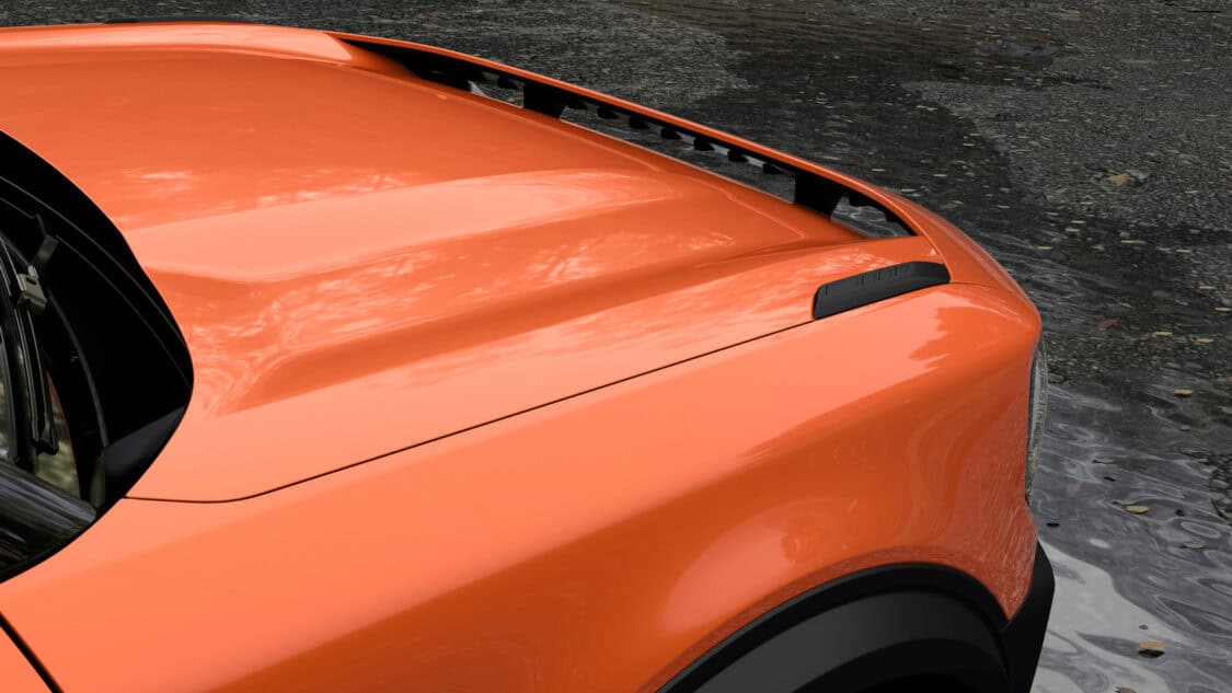 Close-up of the electric Ford Bronco New Energy’s orange front hood, featuring the Badlands badge and signature flush door handle