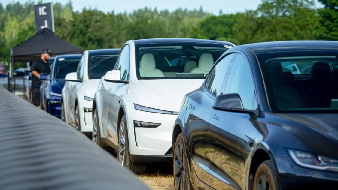 Tesla Model Y demo vehicles lined up at Electrify Expo Seattle 2025, ready for test drives as attendees check in nearby.