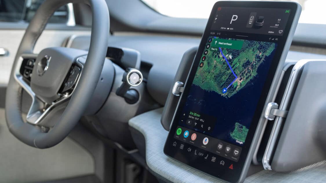 Close-up view of the 2026 Volvo EX30 Cross Country interior featuring the Google-powered infotainment system with navigation on a vertical touchscreen, minimalist dashboard, and steering wheel with integrated controls.