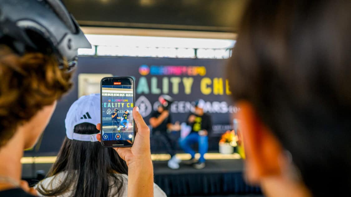 Sur Ronster on stage with Diego Cardenas at Electrify Expo during an EV Reality Check session, powered by GreenCars, filmed for media coverage on electrification and EV technology