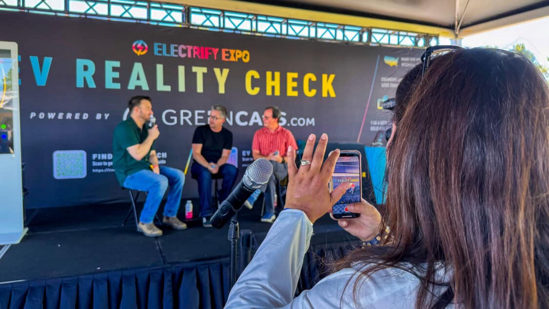 Ethan Esch of ICF and on stage with Matt Teske and Dan O'Shea at Electrify Expo during an EV Reality Check session, powered by GreenCars, filmed for media coverage on electrification and EV technology
