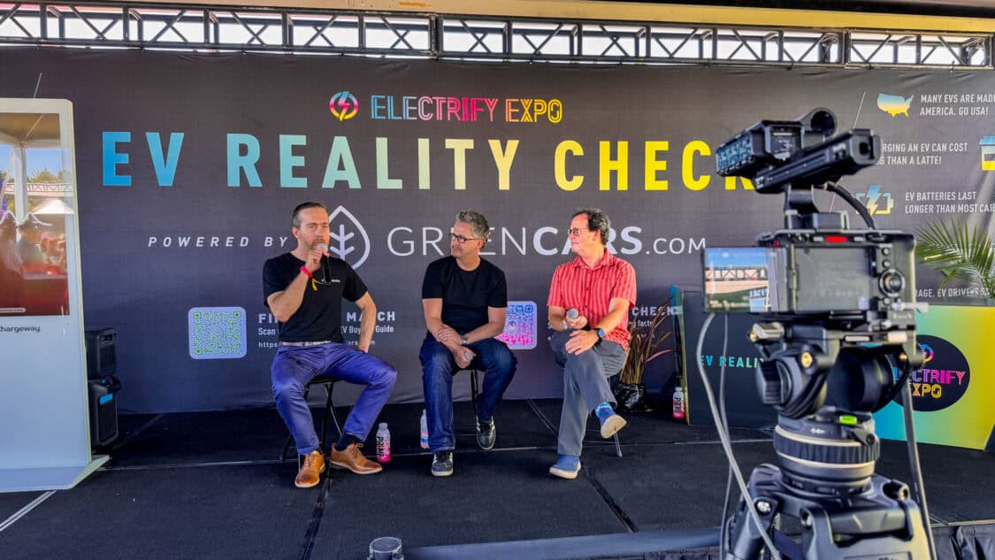 Lang Reynolds of Electric Era on stage with Matt Teske and Dan O'Shea at Electrify Expo during an EV Reality Check session, powered by GreenCars, filmed for media coverage on electrification and EV technology