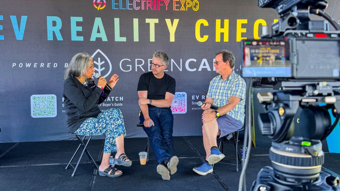Uzma Siddiqi of Seattle City Light on stage with Matt Teske and Dan O'Shea at Electrify Expo during an EV Reality Check session, powered by GreenCars, filmed for media coverage on electrification and EV technology