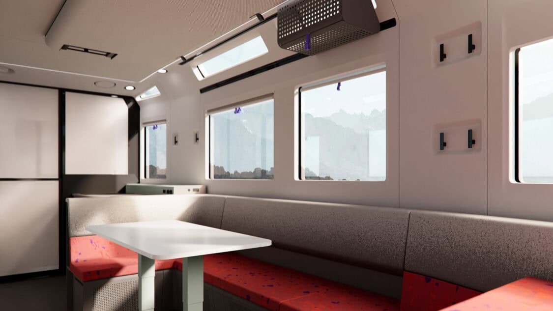 Interior of the Lightship AE.1 Atmos electric trailer with panoramic windows, dining area, and modern NASA-inspired design.