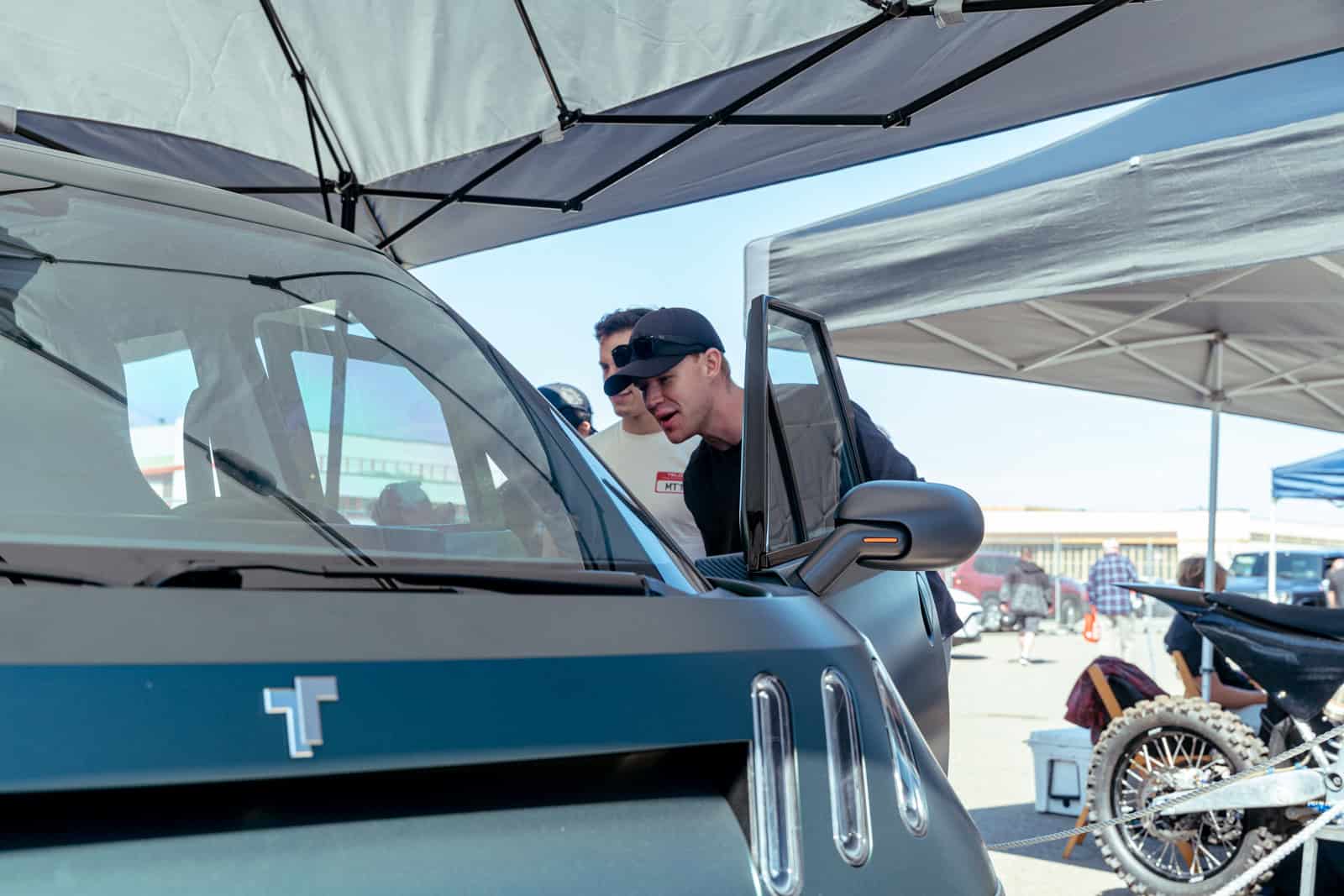Attendees lean in to check out the TELO MT1 electric mini truck on display at Electrify Expo San Francisco.