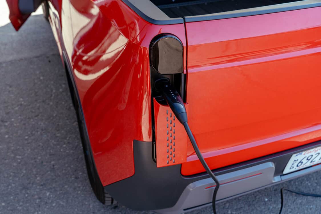 The TELO MT1 electric mini truck plugged in and charging with Tesla NACS adapter and EV charger during Electrify Expo San Francisco.