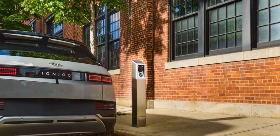A Hyundai Ioniq 5 parked beside an it’s electric curbside charging station in Alameda, supporting renters with clean energy access.