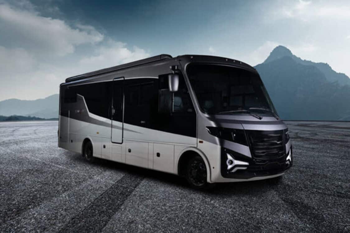 A black and silver Entegra Coach Embark, the world’s first range-extended electric Class A motorhome by THOR Industries, parked against a mountain backdrop.