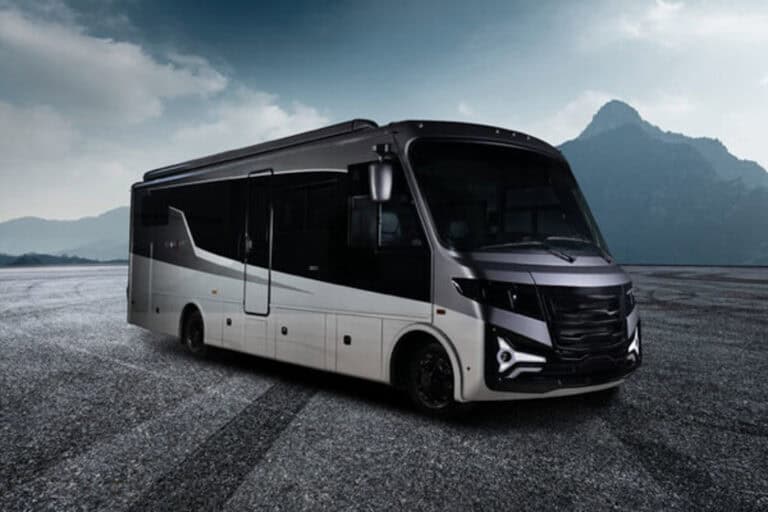 A black and silver Entegra Coach Embark, the world’s first range-extended electric Class A motorhome by THOR Industries, parked against a mountain backdrop.