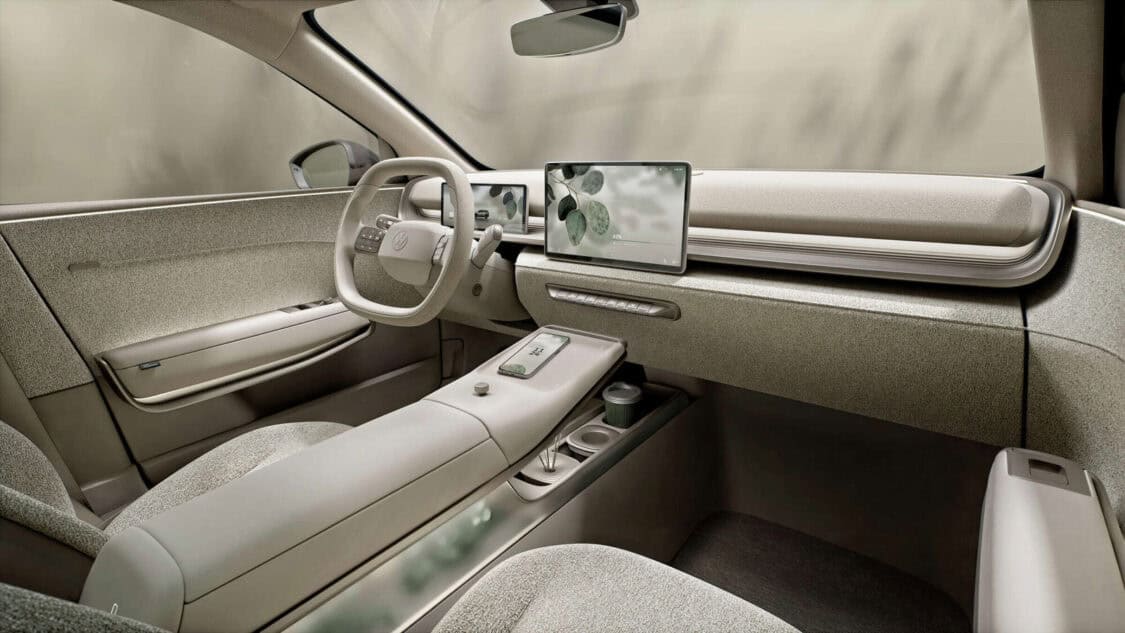 Interior of the Volkswagen ID. CROSS Concept featuring Vanilla Chai lounge design, digital displays, and floating center console with plants.