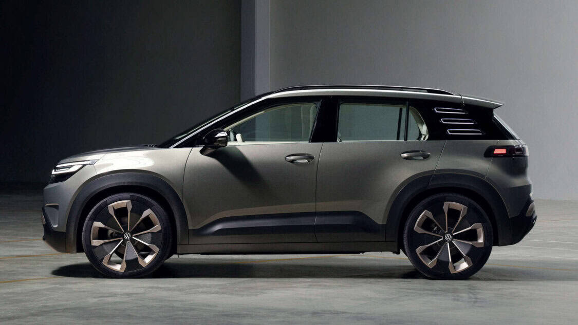 Side view of the Volkswagen ID. CROSS Concept compact electric SUV featuring 3D light signature and Urban Jungle green finish.