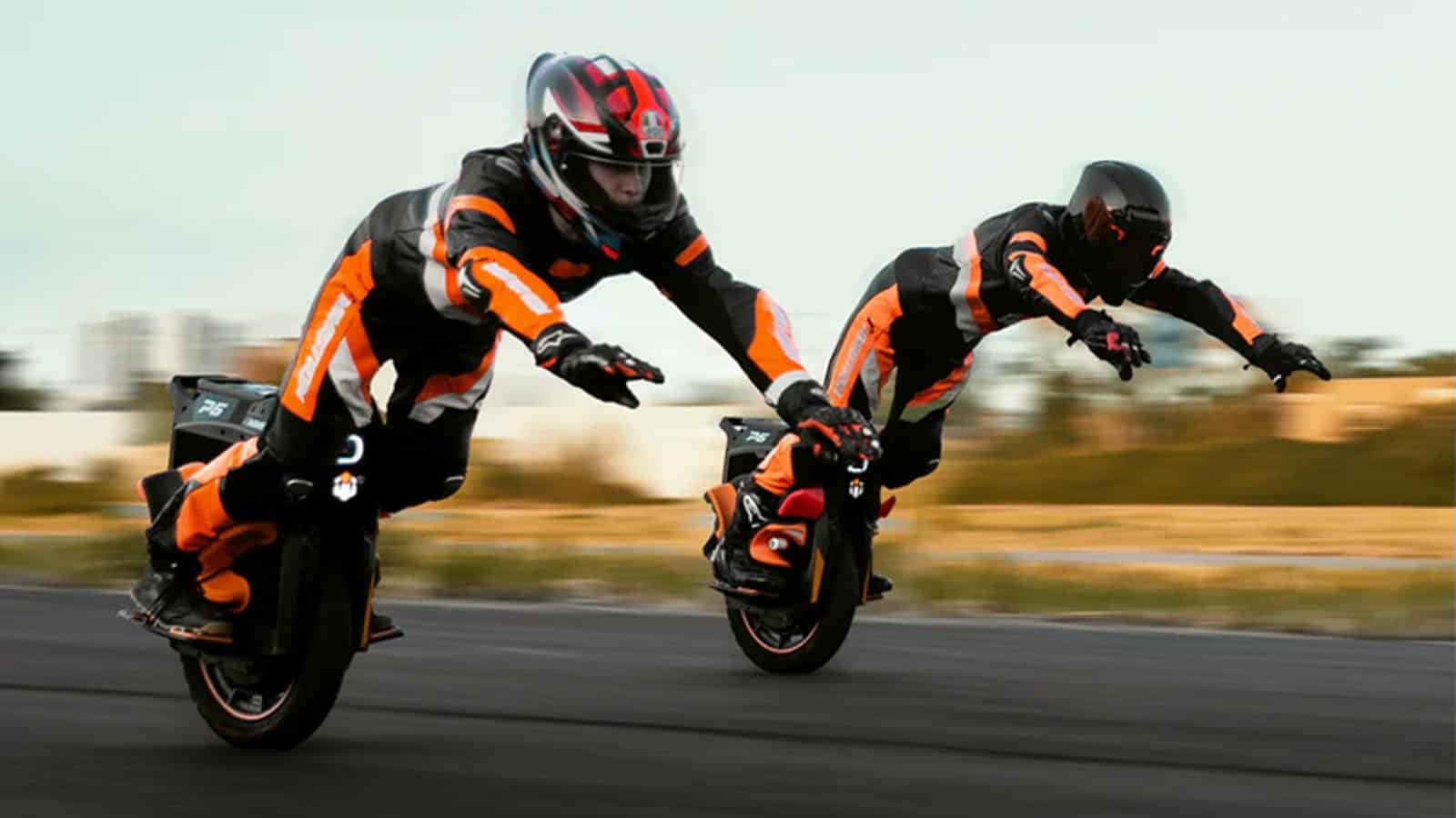 Two riders in racing gear lean forward at high speed on InMotion P6 electric unicycles, demonstrating extreme control and acceleration.